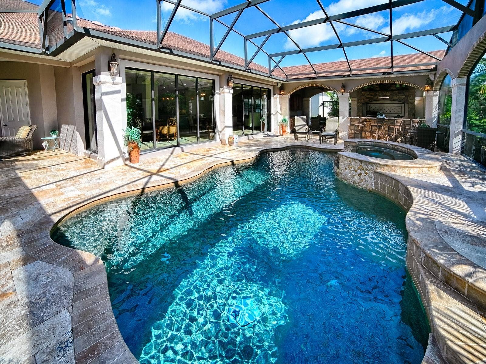 1103 MIONA SHORES DRIVE, The Villages, FL 32162 AN AMAZING SALT WATER HEATED POOL AND SPA WITH TRAVERTINE DECKING AND A SUMMER KITCHEN.