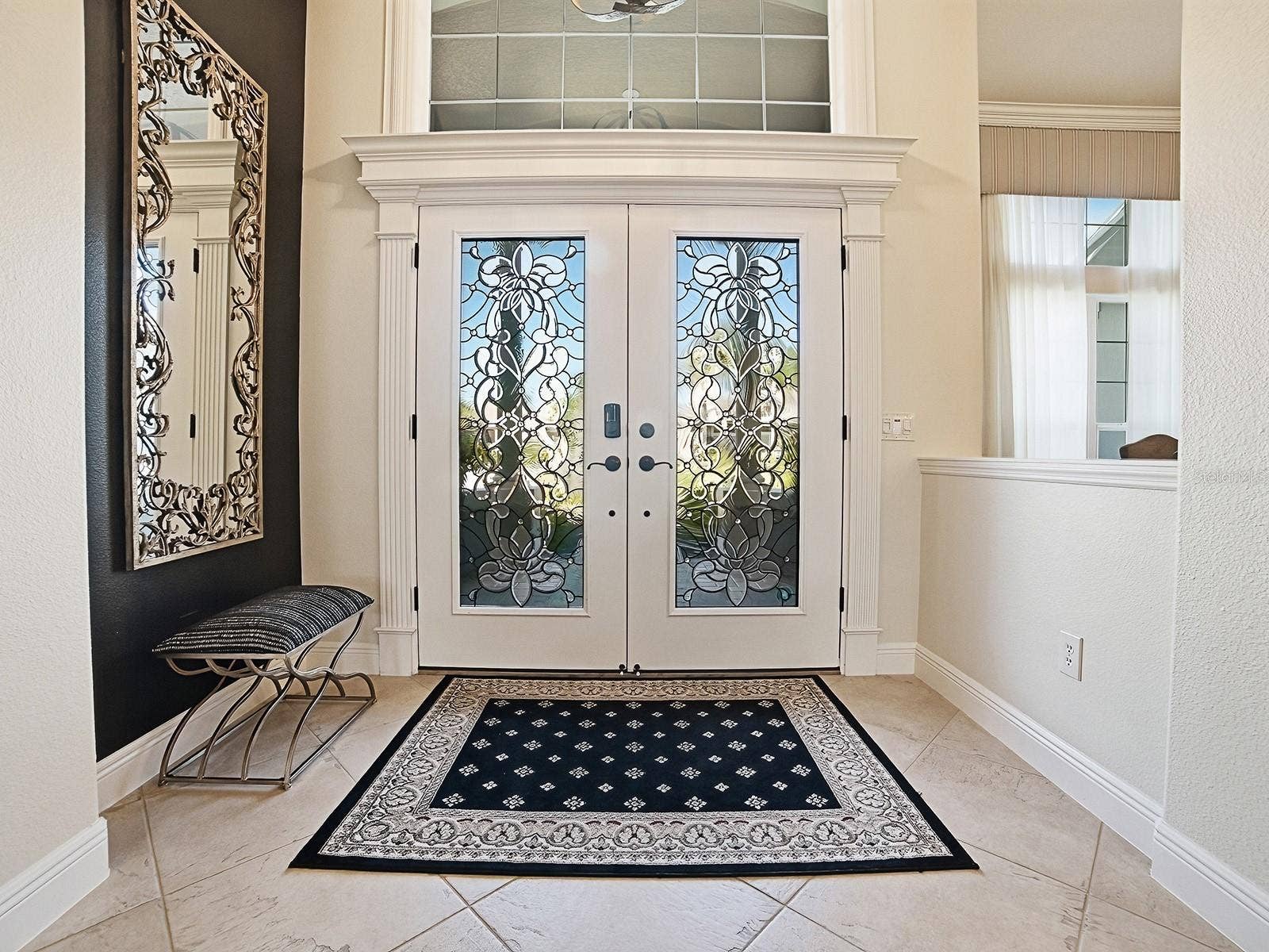 1103 MIONA SHORES DRIVE, The Villages, FL 32162 BEAUTIFUL FOYER WITH TRANSOM AND CUSTOM TRIM AND DIAGONAL TILE FLOORING.