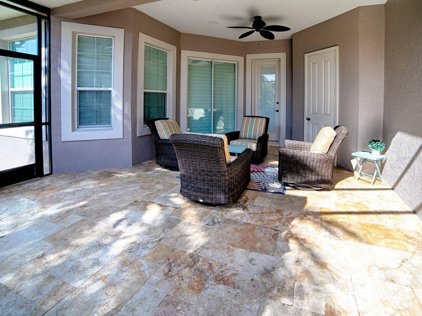 1103 MIONA SHORES DRIVE, The Villages, FL 32162 AROUND THE CORNER IS ANOTHER SEATING AREA, A STORAGE ROOM FOR ALL YOUR POOL EQUIPMENT, A POOL BATH AND THE SLIDING GLASS DOORS LEAD TO THE PRIMARY BEDROOM.