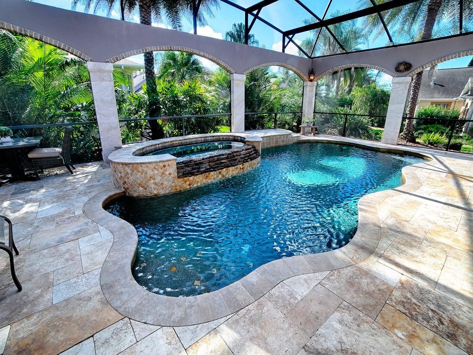 1103 MIONA SHORES DRIVE, The Villages, FL 32162 BEAUTIFUL SALT WATER POOL AND SPA SURROUNDED BY STONE COLUMNS AND TROPICAL LANDSCAPING FOR COMPLETE PRIVACY.