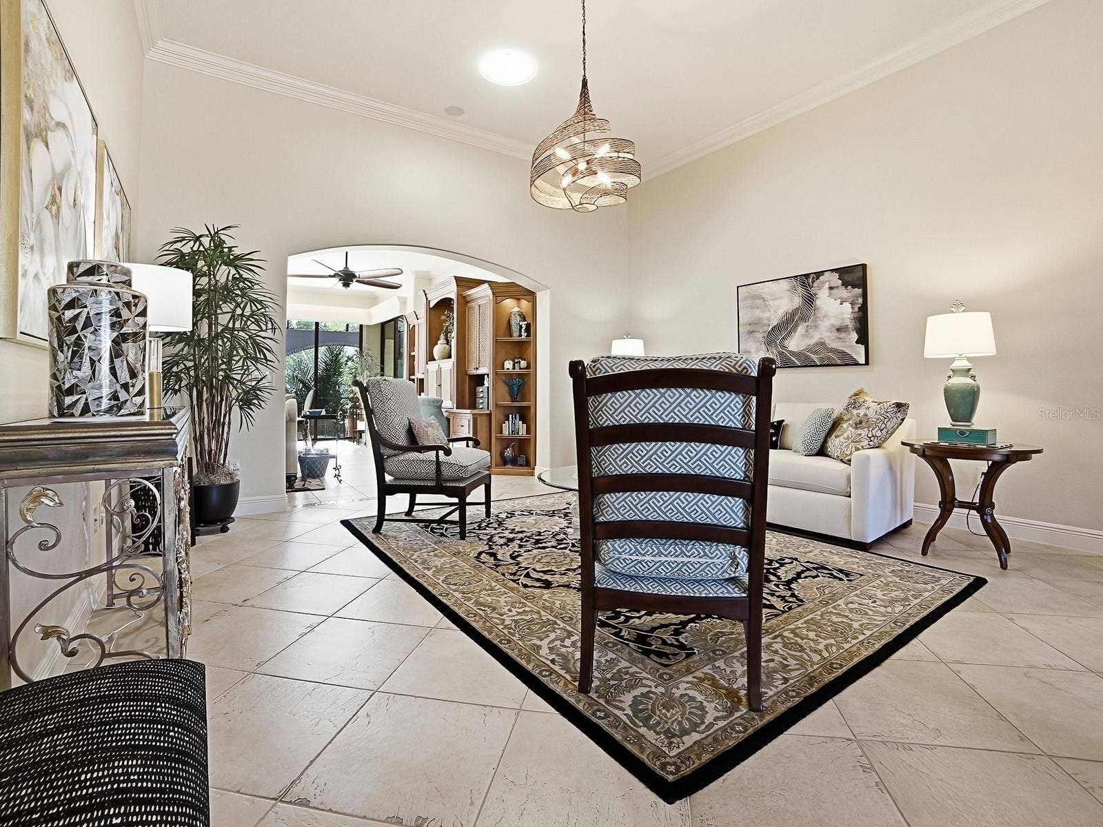 1103 MIONA SHORES DRIVE, The Villages, FL 32162 FROM THE FOYER, STEP INTO YOUR FORMAL LIVING ROOM THAT FLOWS INTO THE ADDED BONUS AREA AND FAMILY ROOM.