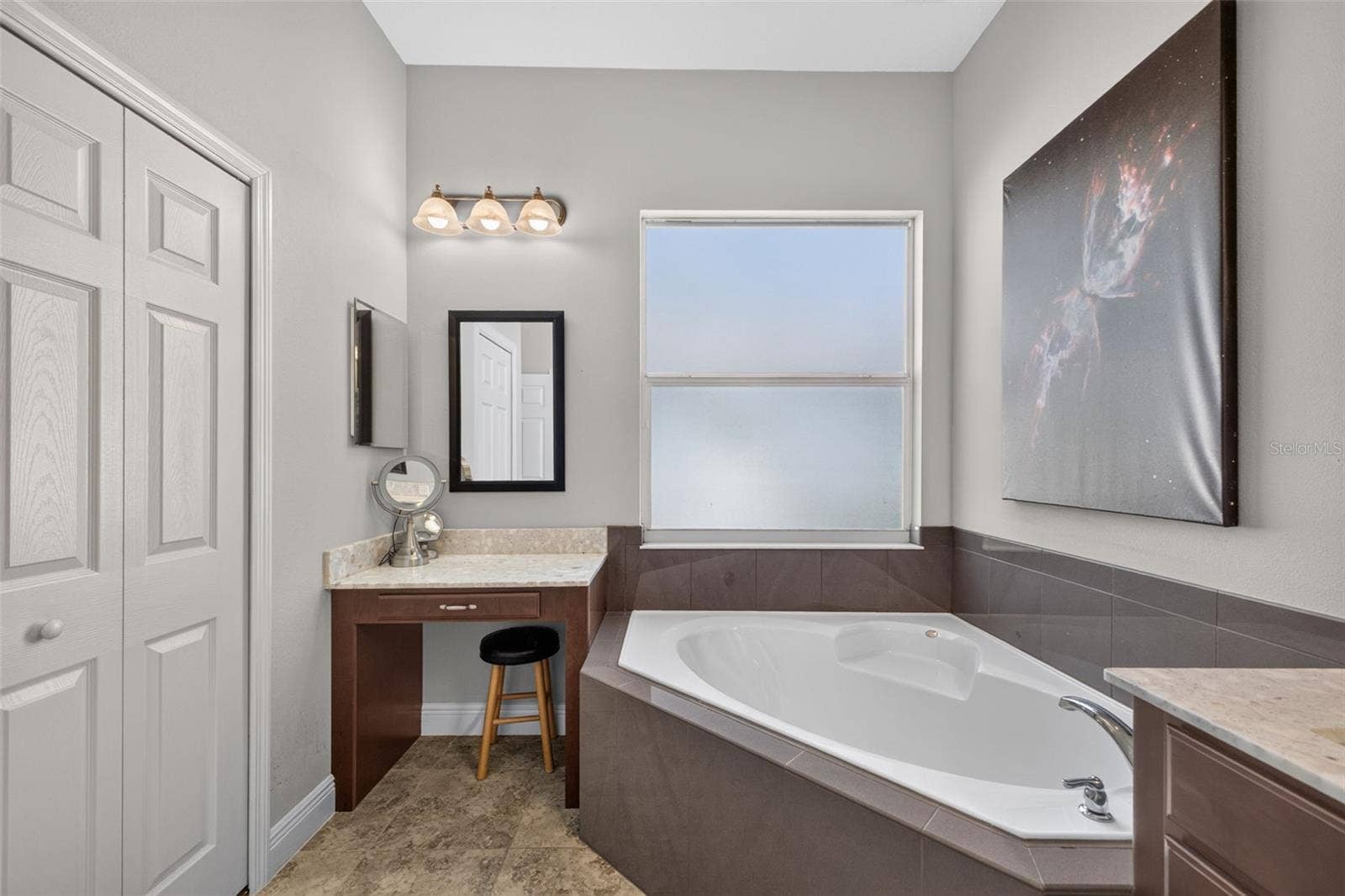 2444 PAWTUCKET PASS, Mount Dora, FL 32757 Pamper yourself in an elegant primary bath complete with a built-in makeup vanity and ample closet storage.