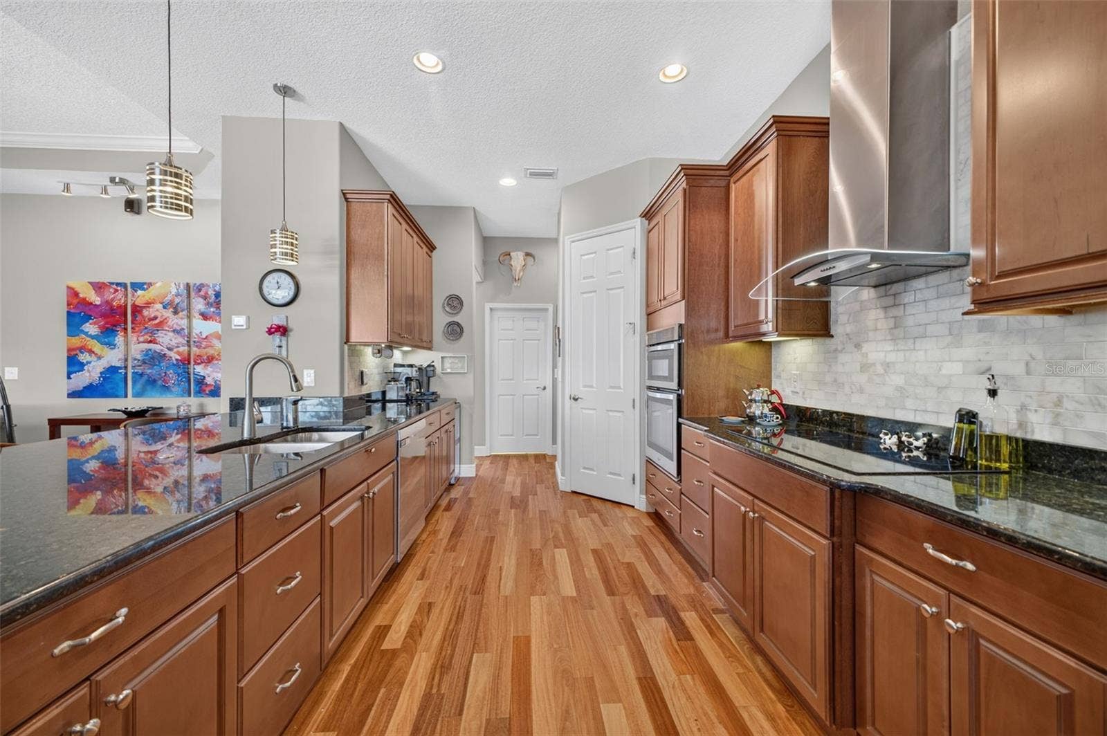 2444 PAWTUCKET PASS, Mount Dora, FL 32757 The beautifully appointed kitchen opens conveniently to a walk-in pantry and a dedicated indoor laundry room.