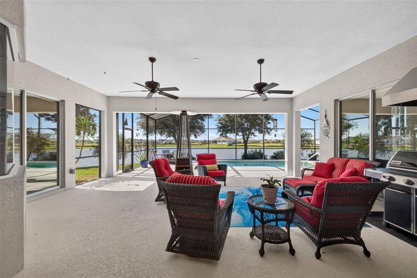 2444 PAWTUCKET PASS, Mount Dora, FL 32757 The lanai is spacious and has plenty of space in the shade, with easy access to the pool and sunshine.
