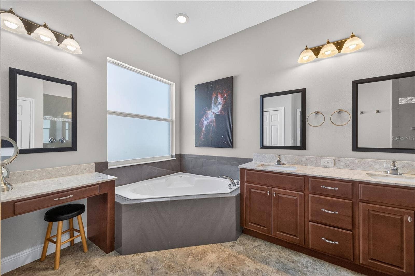 2444 PAWTUCKET PASS, Mount Dora, FL 32757 The spa-inspired en-suite bath features an oversized garden tub, offering a tranquil retreat for evening relaxation.