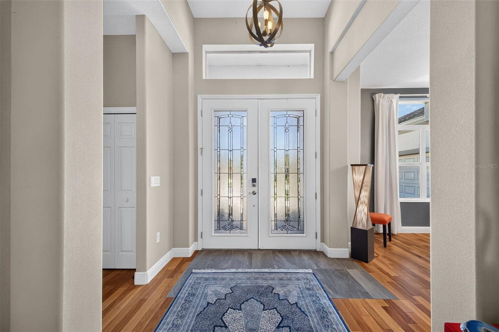2444 PAWTUCKET PASS, Mount Dora, FL 32757 Make a memorable entrance in a dramatic, sun-filled foyer highlighted by soaring ceilings and architectural elegance.