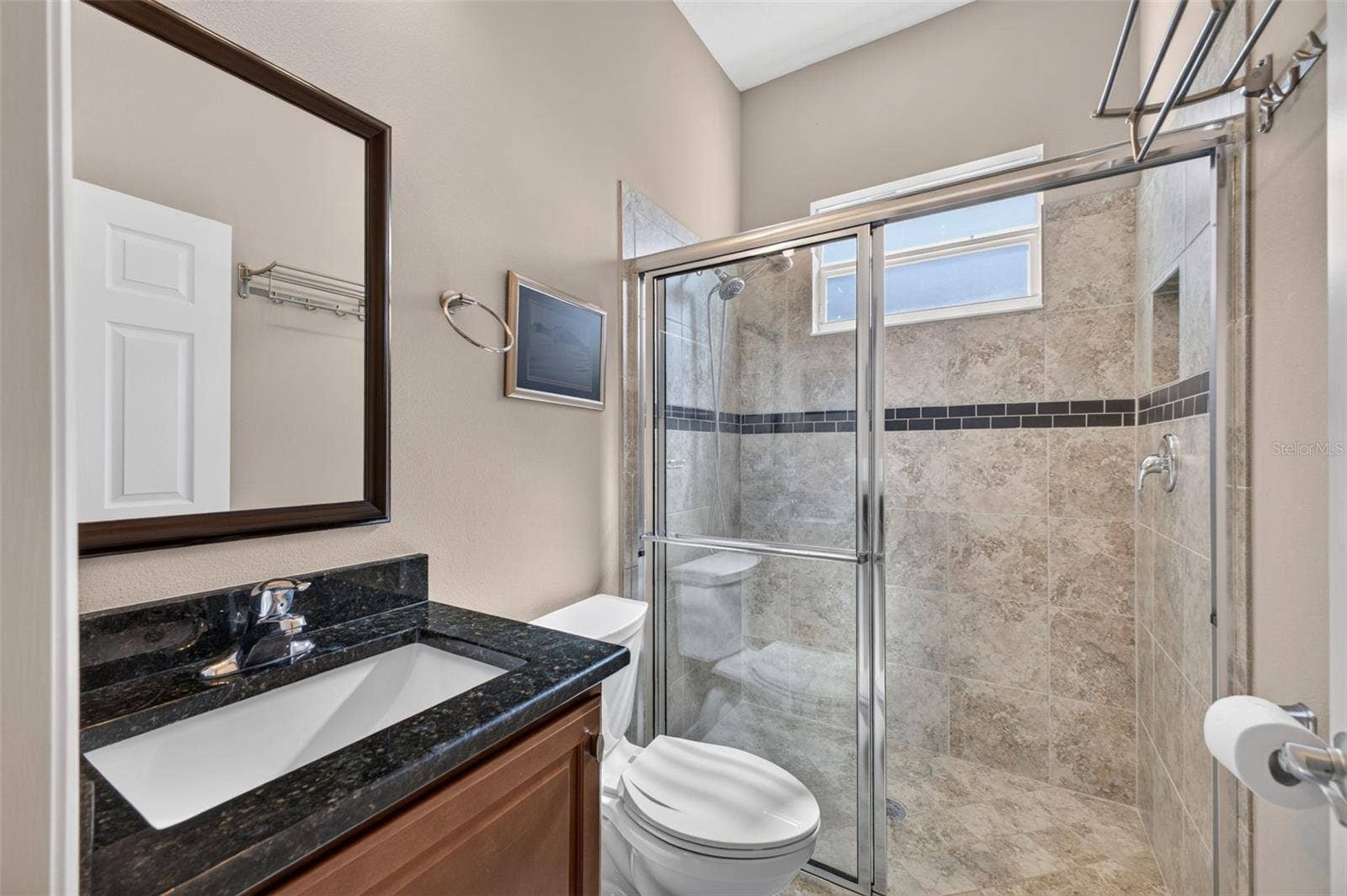 2444 PAWTUCKET PASS, Mount Dora, FL 32757 Appointed with rich granite countertops and a glass-enclosed walk-in shower, this second bath combines style and convenience.
