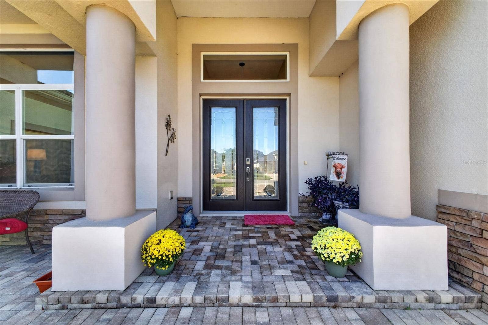 2444 PAWTUCKET PASS, Mount Dora, FL 32757 An inviting front porch sets a sophisticated tone upon arrival, complete with beveled glass double doors that seamlessly blend privacy with natural light.