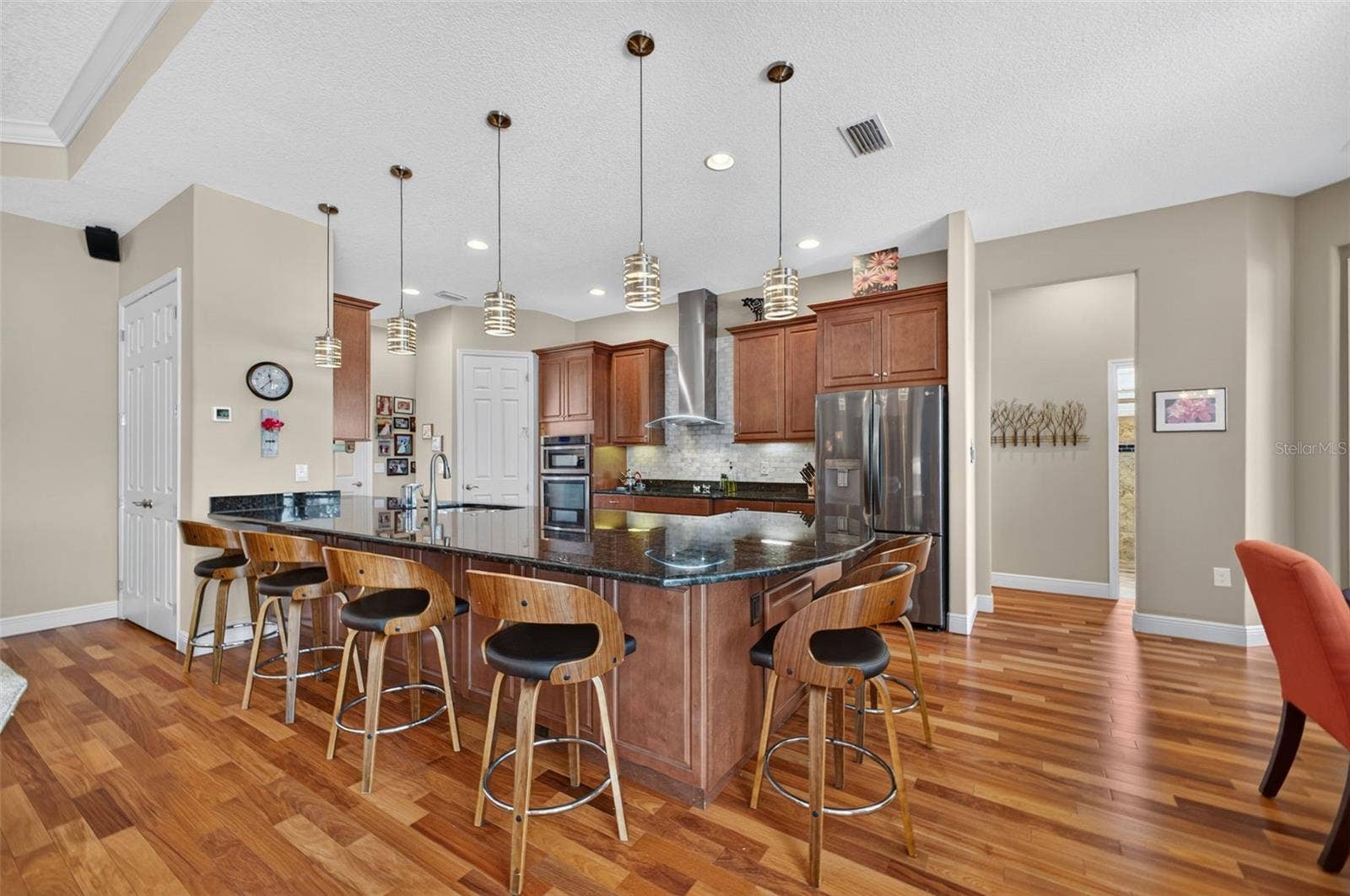 2444 PAWTUCKET PASS, Mount Dora, FL 32757 Stylish pendant lights illuminate and accent the spacious kitchen peninsula.