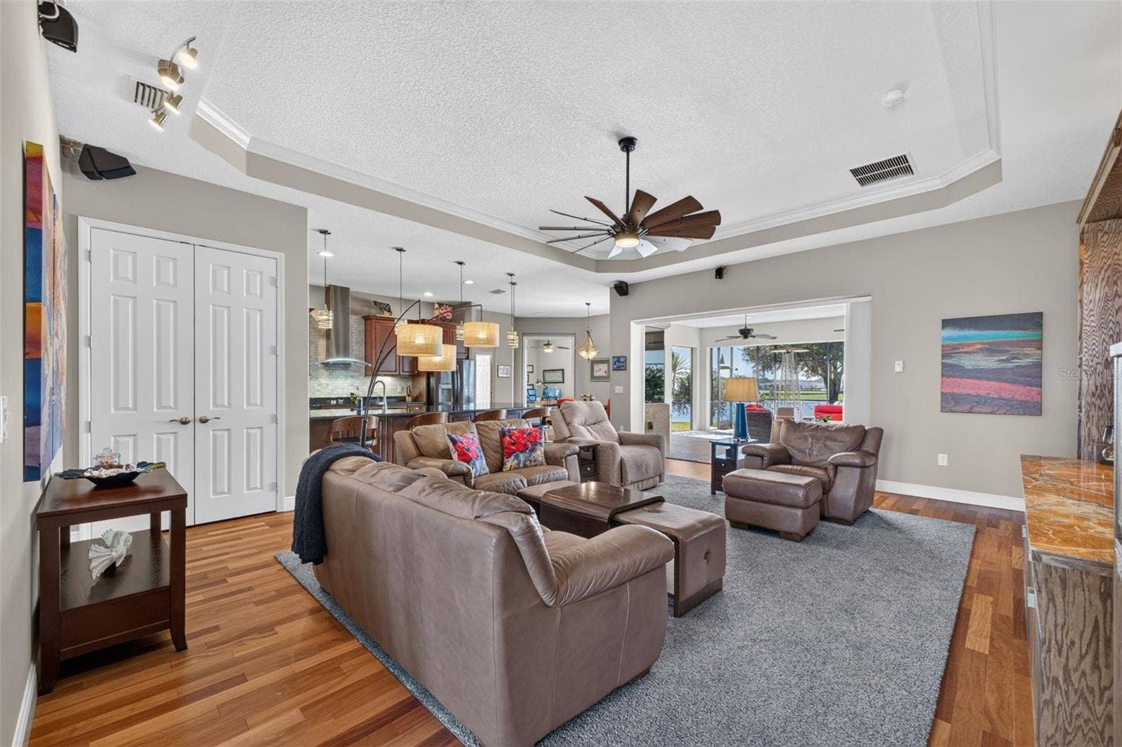 2444 PAWTUCKET PASS, Mount Dora, FL 32757 An expansive great room flows effortlessly into the casual dining area and kitchen, creating the ultimate hub for daily living and entertaining.