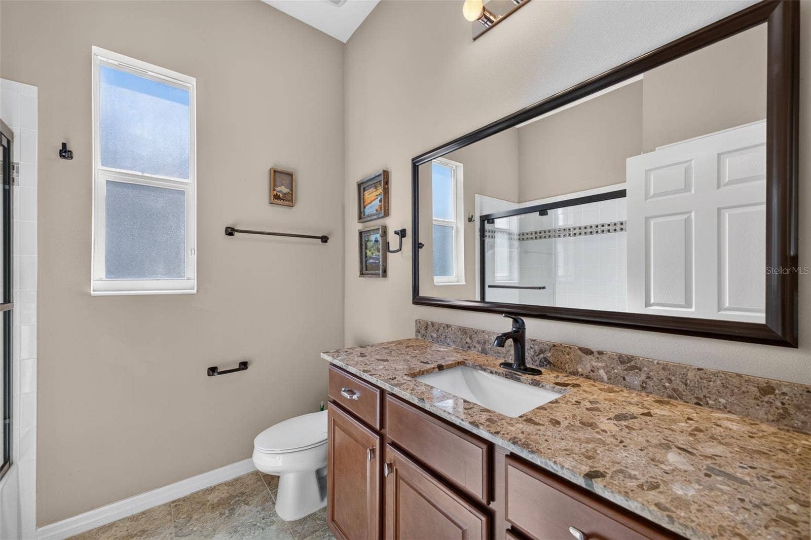 2444 PAWTUCKET PASS, Mount Dora, FL 32757 Appointed with rich granite counter surfaces, this third bath features a full tub and shower combination for modern convenience.