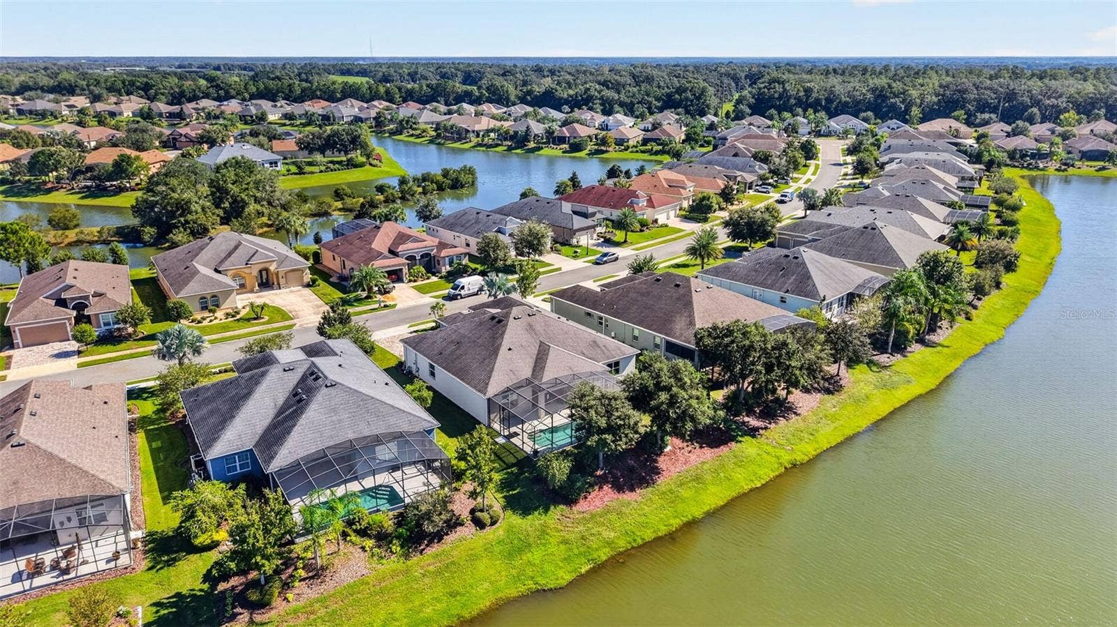 2444 PAWTUCKET PASS, Mount Dora, FL 32757 An impressive aerial perspective of the premier waterfront homes situated along peaceful Pawtucket Pass.