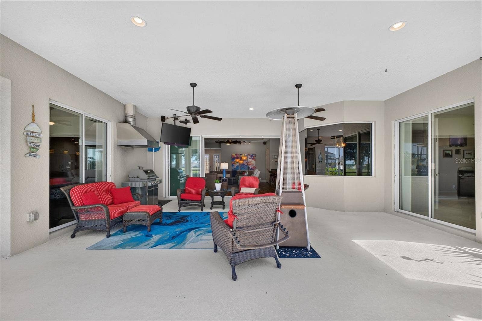 2444 PAWTUCKET PASS, Mount Dora, FL 32757 Designed for resort-style relaxation, the spacious covered lanai provides a seamless outdoor living area perfect for post-pool lounging and entertaining.
