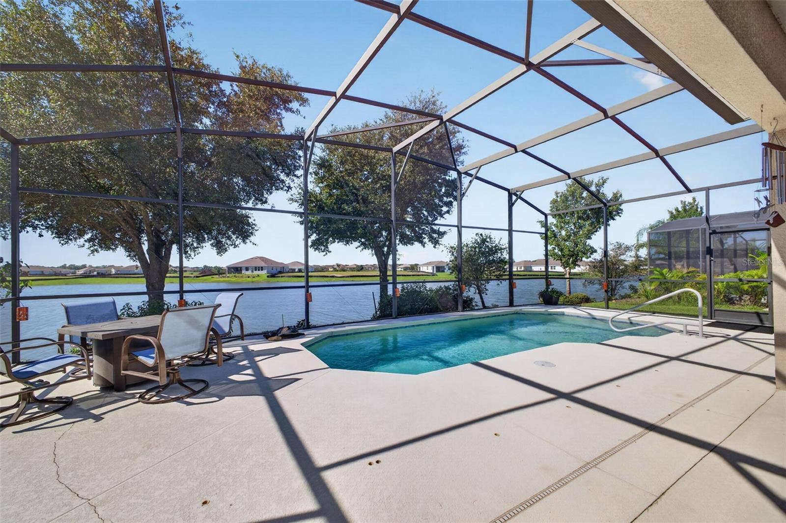 2444 PAWTUCKET PASS, Mount Dora, FL 32757 A sparkling pool set against scenic lake views creates the ultimate outdoor oasis for relaxation and entertaining.