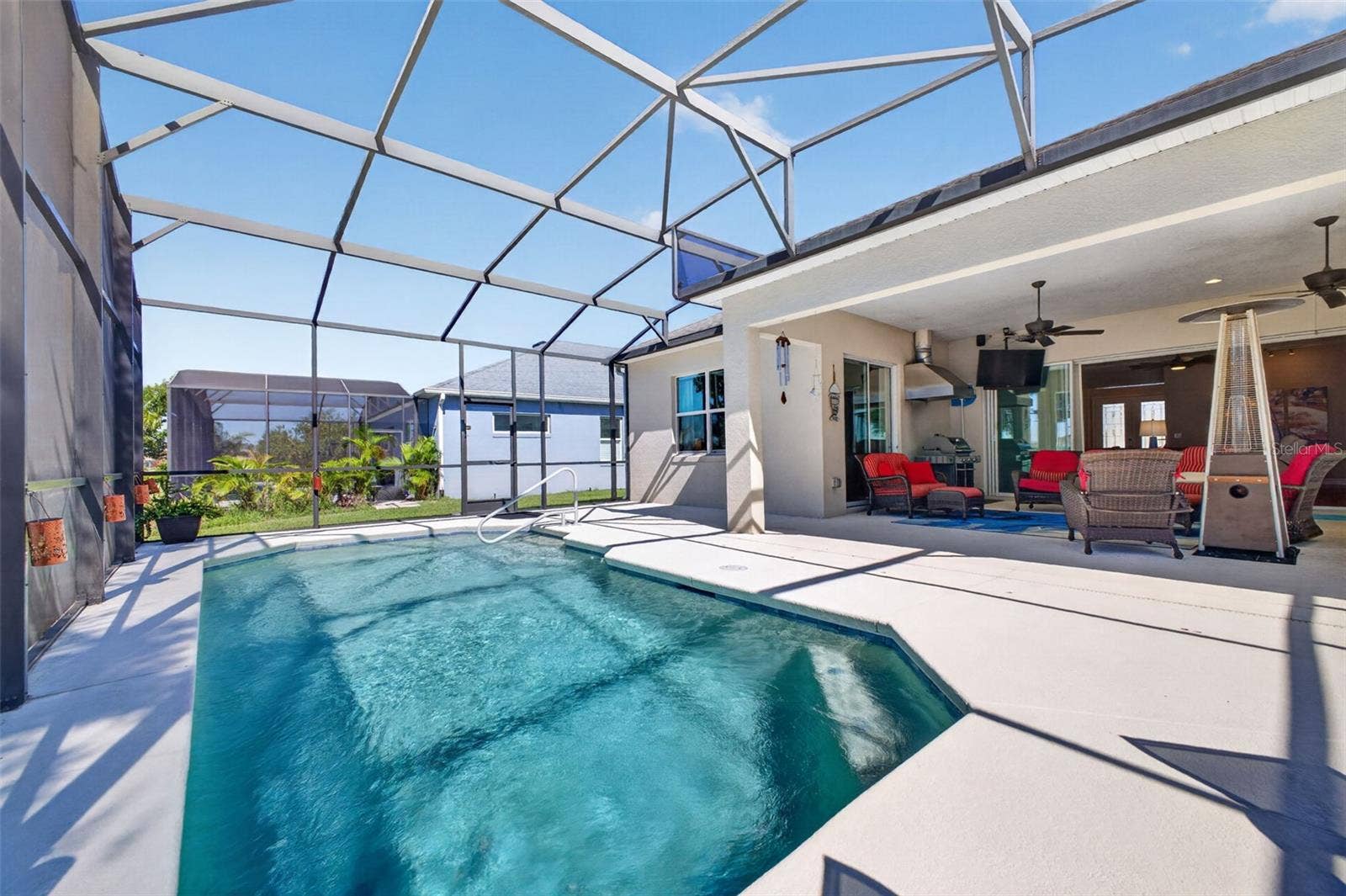 2444 PAWTUCKET PASS, Mount Dora, FL 32757 A screened pool cage offers easy, low-maintenance living for the generous 23' x 13' swimming pool.