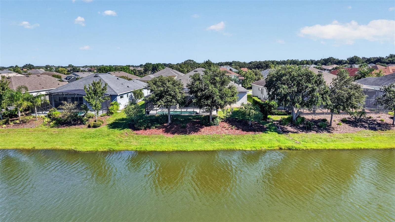 2444 PAWTUCKET PASS, Mount Dora, FL 32757 Mature oak trees line the rear of the property, providing natural shade and added privacy.