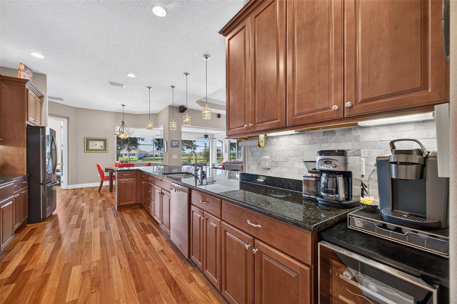 2444 PAWTUCKET PASS, Mount Dora, FL 32757 Under-cabinet lighting adds both warm atmosphere and practical task illumination to the workspace.