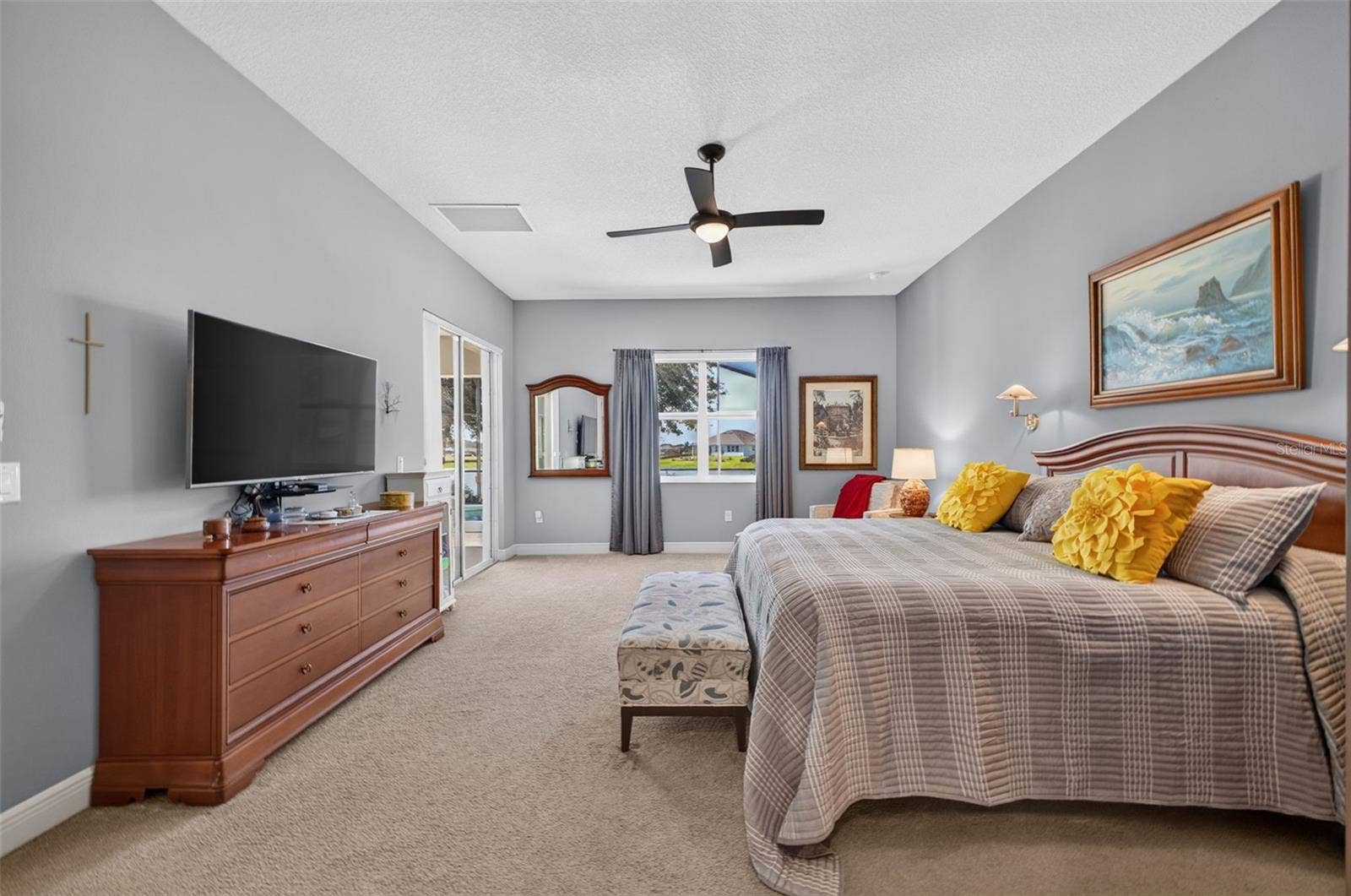 2444 PAWTUCKET PASS, Mount Dora, FL 32757 Positioned at the back of the home to capture sweeping lake views, this expansive primary retreat offers seamless indoor-outdoor flow to the pool and lanai.