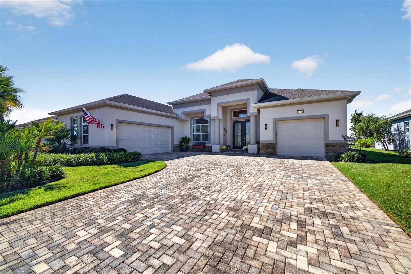 2444 PAWTUCKET PASS, Mount Dora, FL 32757 An expansive paver driveway offers ample parking and sets a warm, elegant tone the moment you arrive.