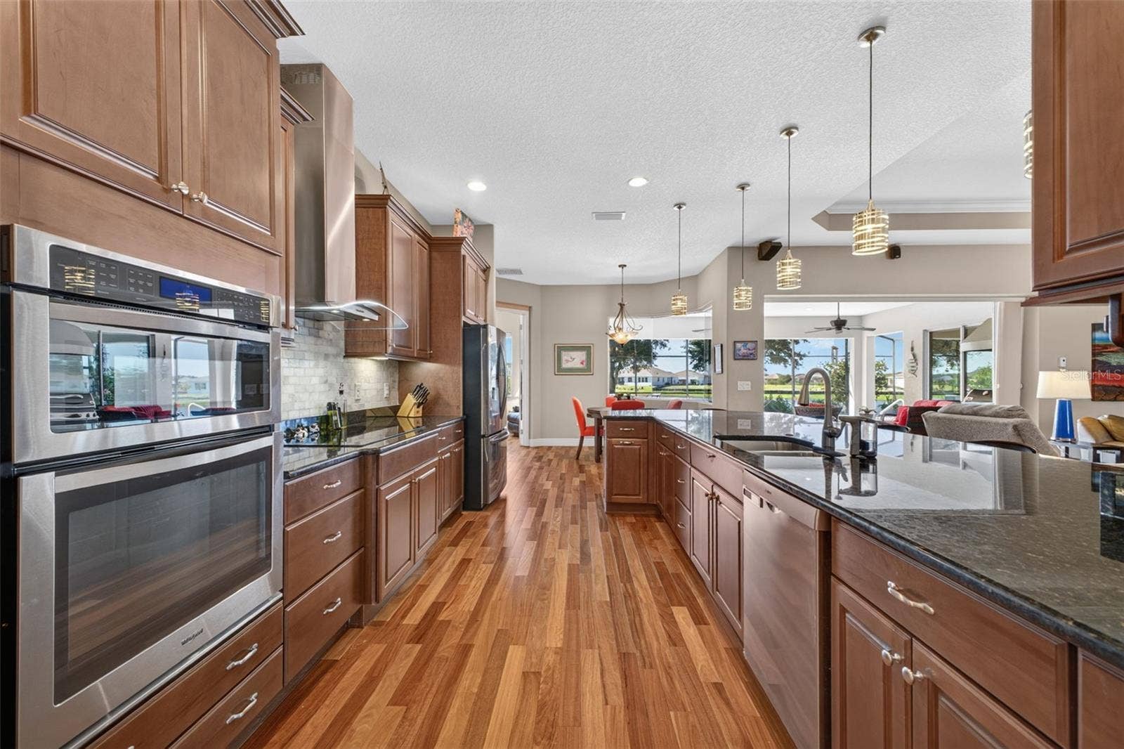 2444 PAWTUCKET PASS, Mount Dora, FL 32757 Double-oven configuration, featuring a built-in microwave/convection oven combination set above a traditional wall oven.