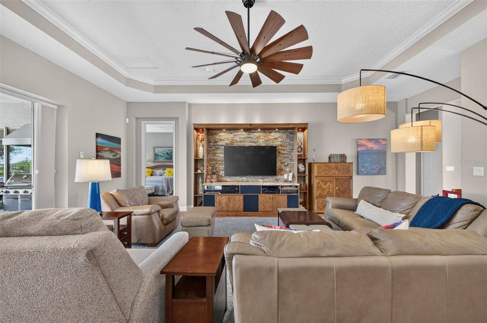 2444 PAWTUCKET PASS, Mount Dora, FL 32757 Disappearing pocket sliders open fully to merge indoor luxury with outdoor bliss, showcasing panoramic lake views and a shimmering pool.