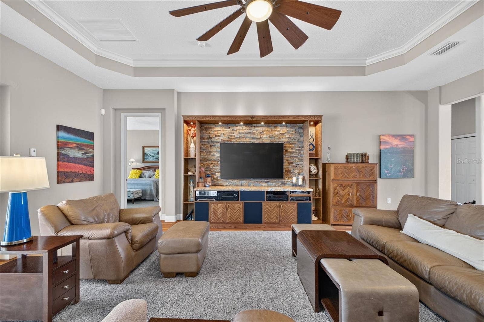 2444 PAWTUCKET PASS, Mount Dora, FL 32757 Sophisticated 11-foot coffered ceilings and an expansive open floor plan anchor this light-filled great room.