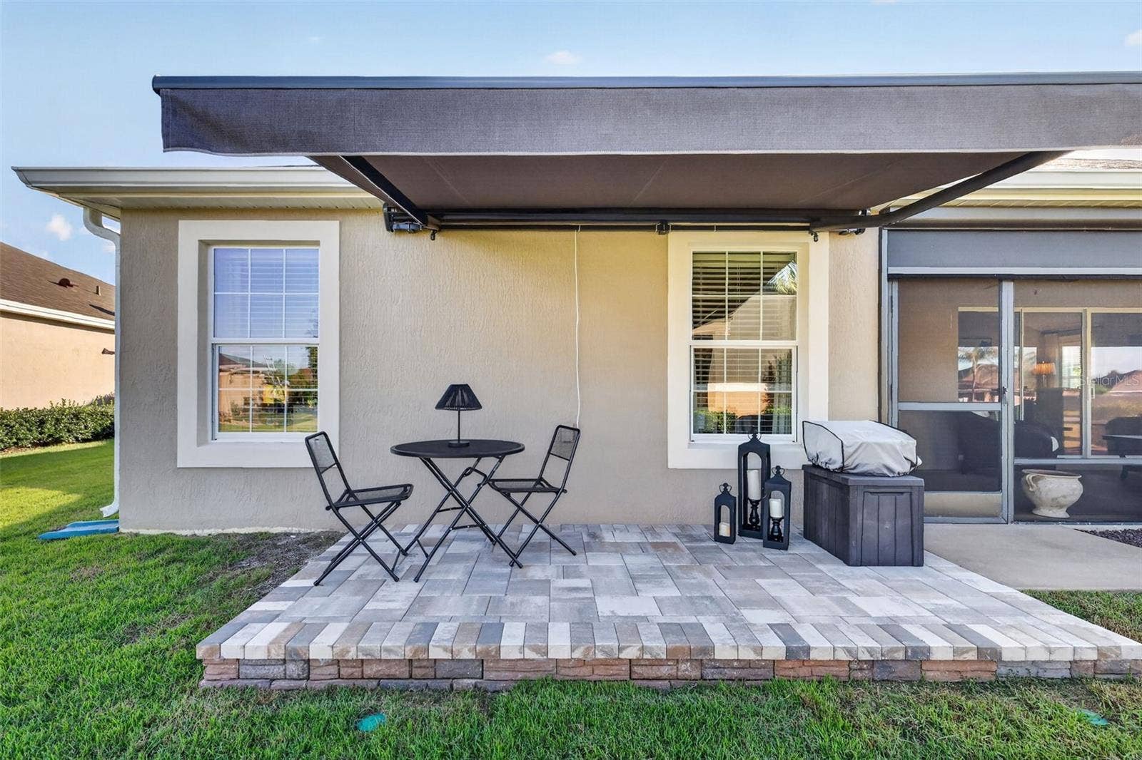 1793 WAX BERRY COURT, The Villages, FL 32163 Side Paver Patio with Remote-Controlled Awning