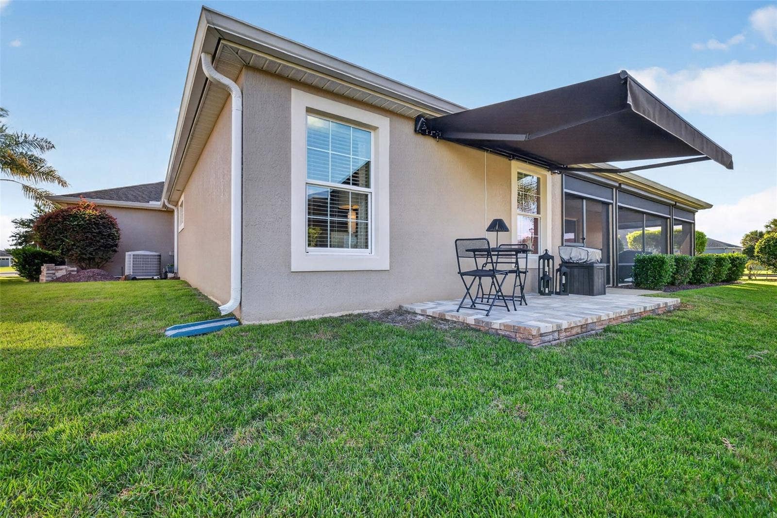 1793 WAX BERRY COURT, The Villages, FL 32163 Side Paver Patio with Remote-Controlled Awning