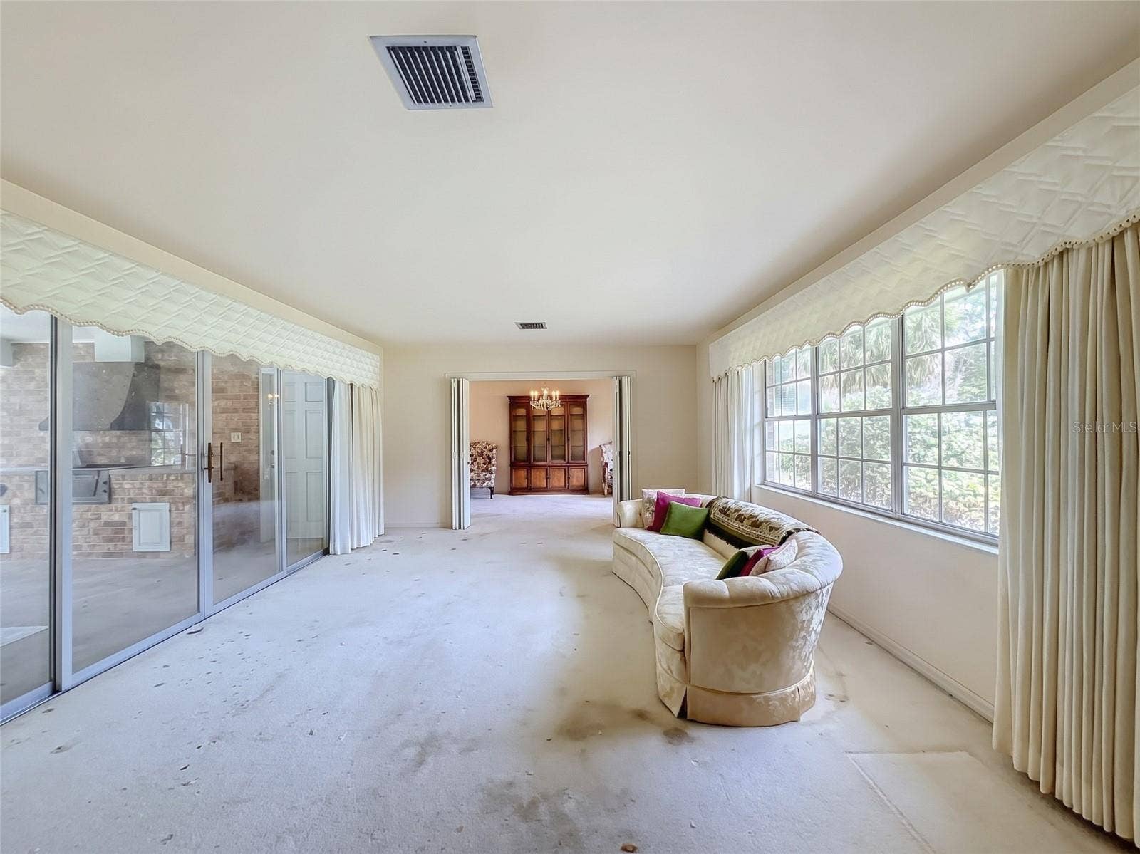 8038 SPRING DRIVE, Yalaha, FL 34797 Living Room with Sliding Glass Doors to Pool