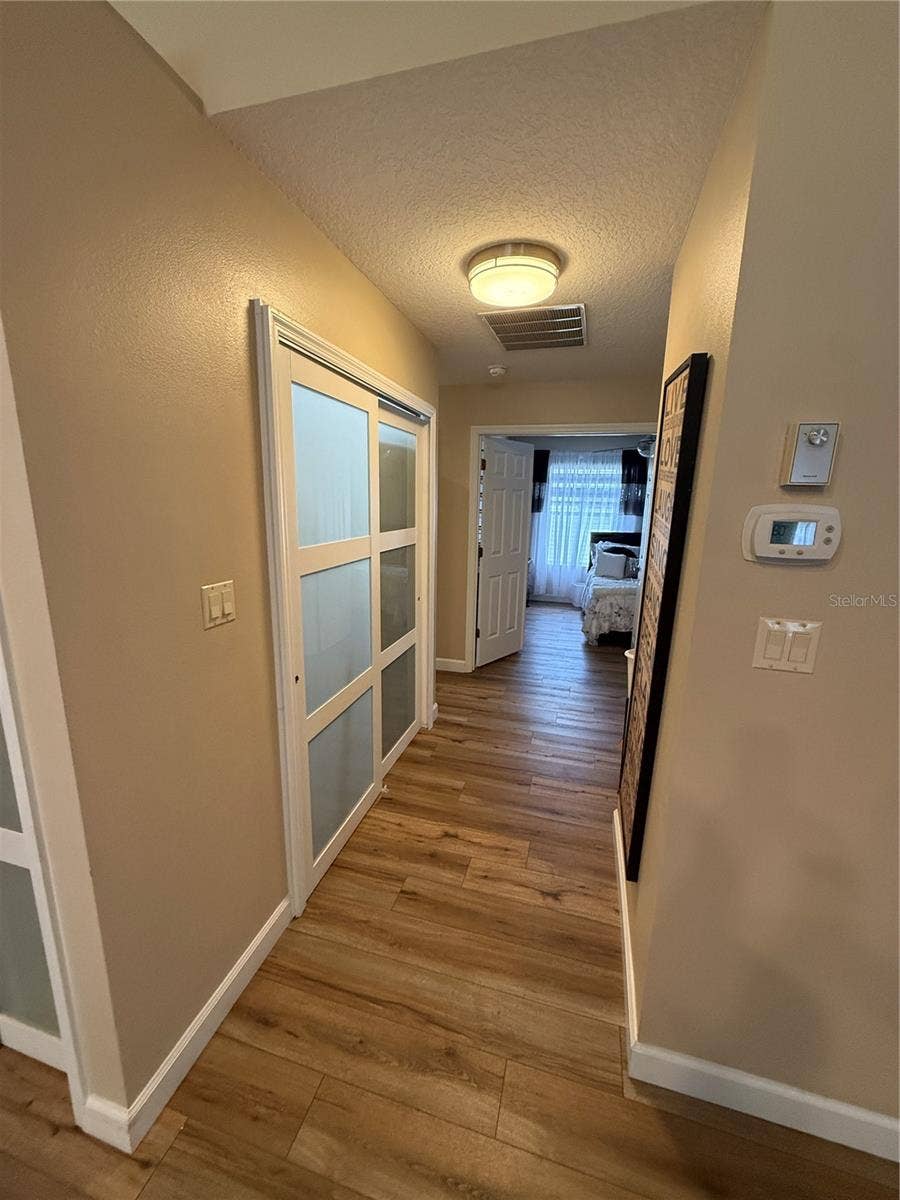 24907 CRANES ROOST CIRCLE, Leesburg, FL 34748 hall from kitchen to bedrooms passing laundry