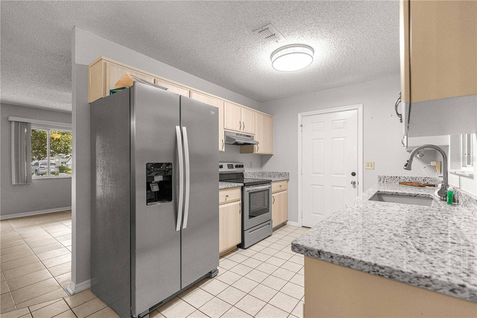 10434 SE 178TH PLACE, Summerfield, FL 34491 KITCHEN STAINLESS STEEL APPLIANCES TO FRONT LIVING ROOM WINDOW VIEW