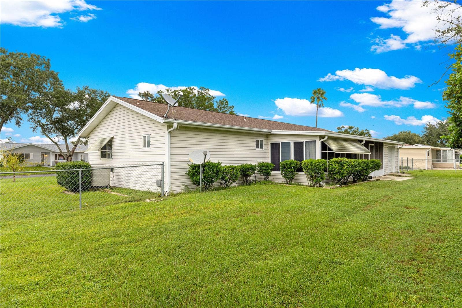10434 SE 178TH PLACE, Summerfield, FL 34491 BACK ANGLE VIEW FROM LEFT TO BACK OF HOME H.V.A.C. IS SHOWING HERE ALSO