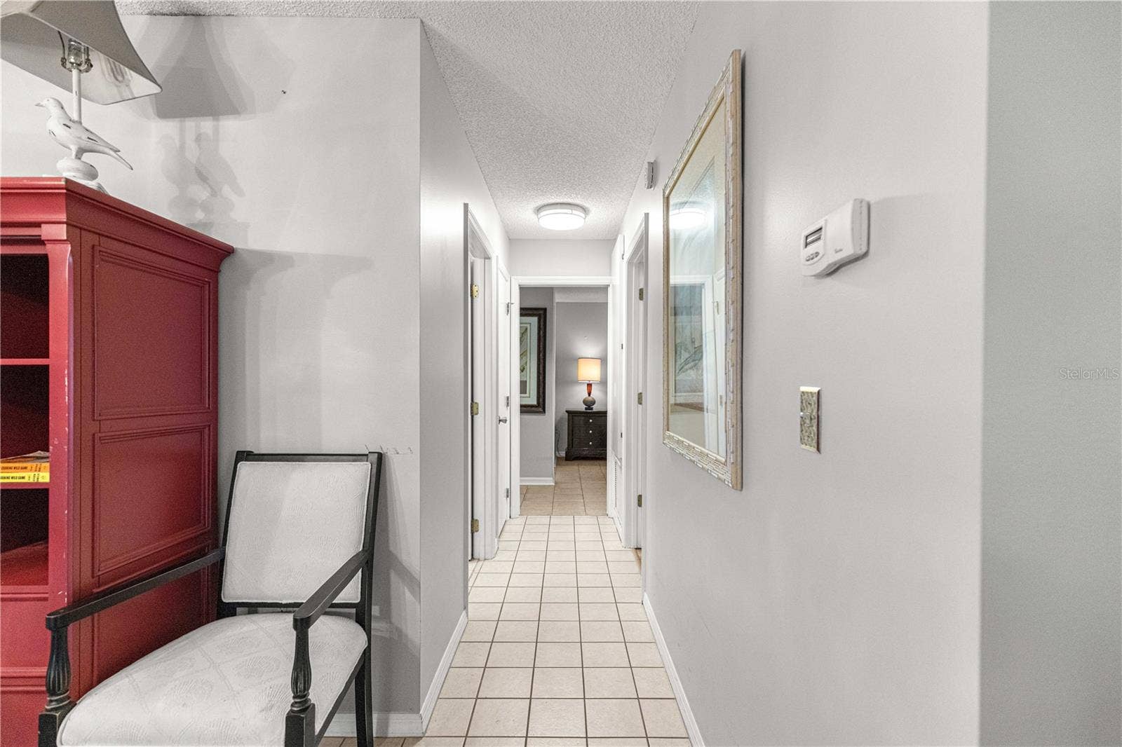 10434 SE 178TH PLACE, Summerfield, FL 34491 TILED HALLWAY TO BEDROOMS FROM DINING AREA