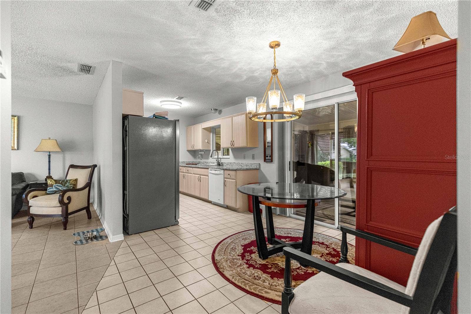 10434 SE 178TH PLACE, Summerfield, FL 34491 LIVING ROOM TO DINING , KITCHEN AND FLORIDA ROOM SLIDING DOORS