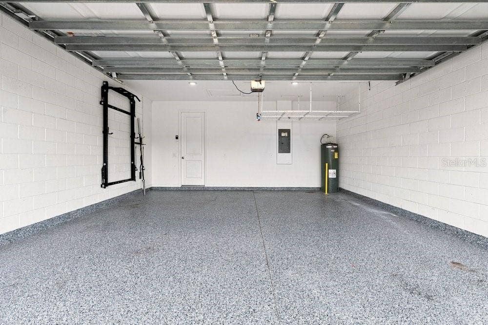 Garage with Epoxy Floors, shelf, and power rack
