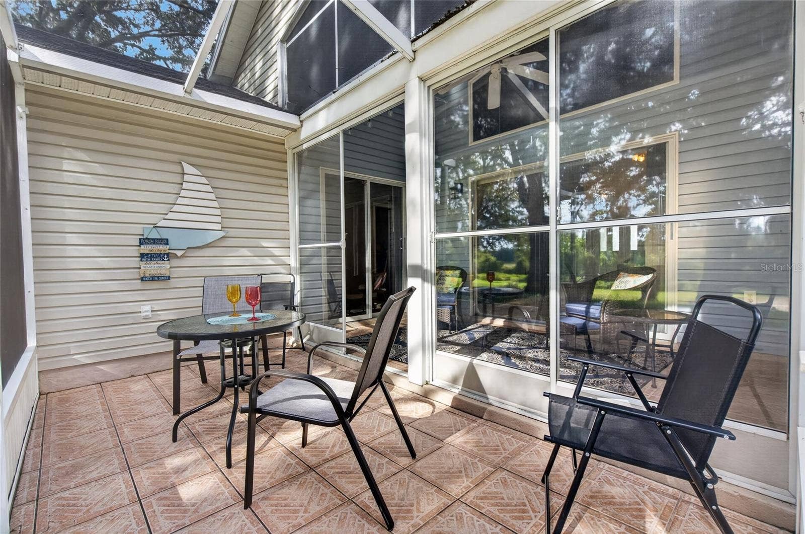 25005 CRANES ROOST CIRCLE, Leesburg, FL 34748 Screened Lanai overlooks wooded backyard and golf course