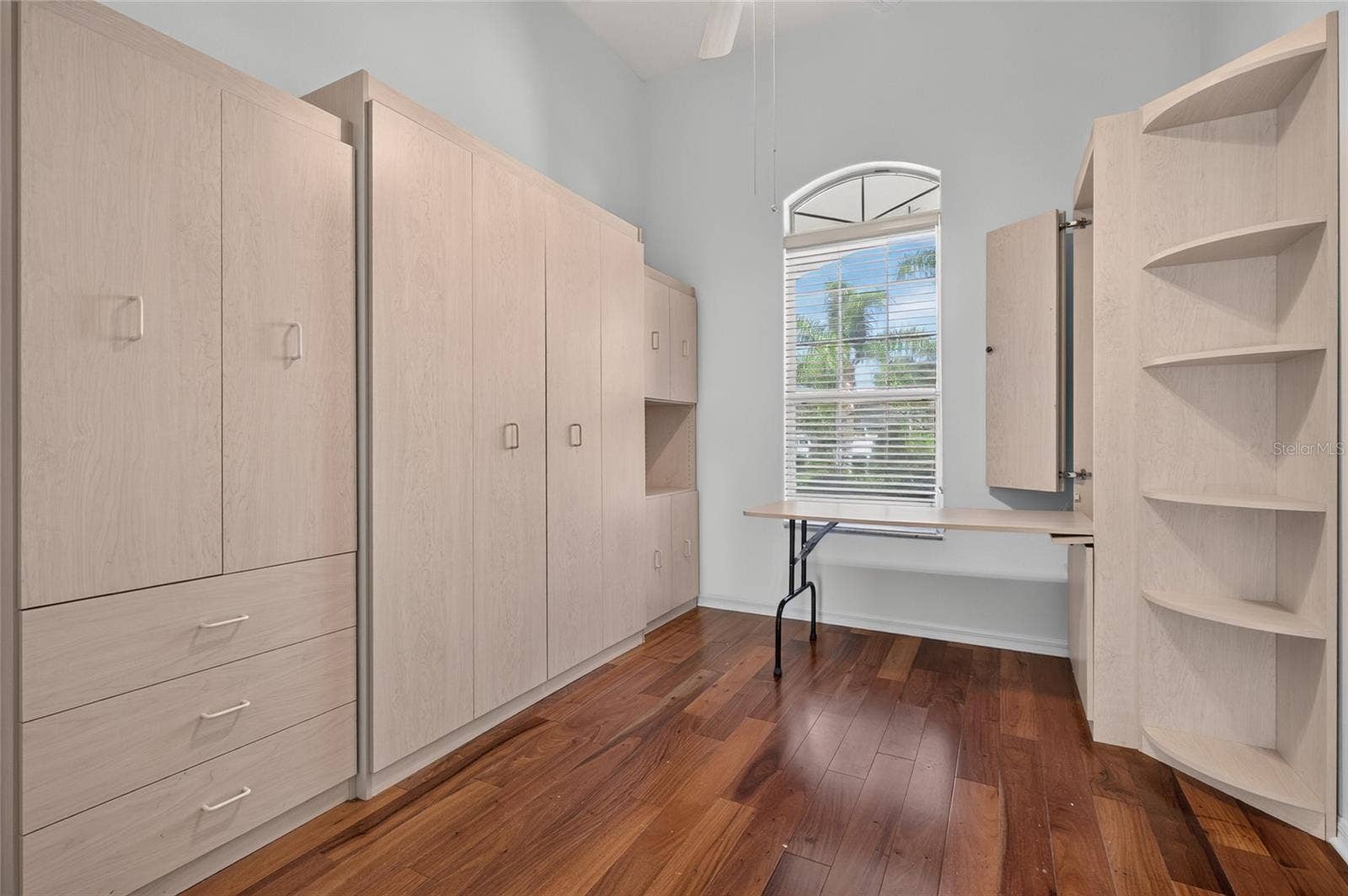24151 BELLE MEDE DRIVE, Leesburg, FL 34748 THIRD BEDROOM/OFFICE. FUNCTION AT IT BEST CUSTOM BUILT IN. MURPHY BED, DROP DOWN DESK, AND STORGE CLOSET AND DRAWERS.