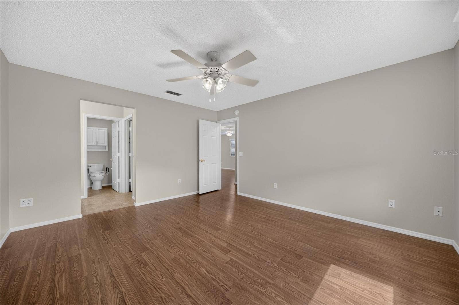 PRIMARY BEDROOM - Broad wall space and a spacious open floor area offer room for king-size bedding and furnishings.