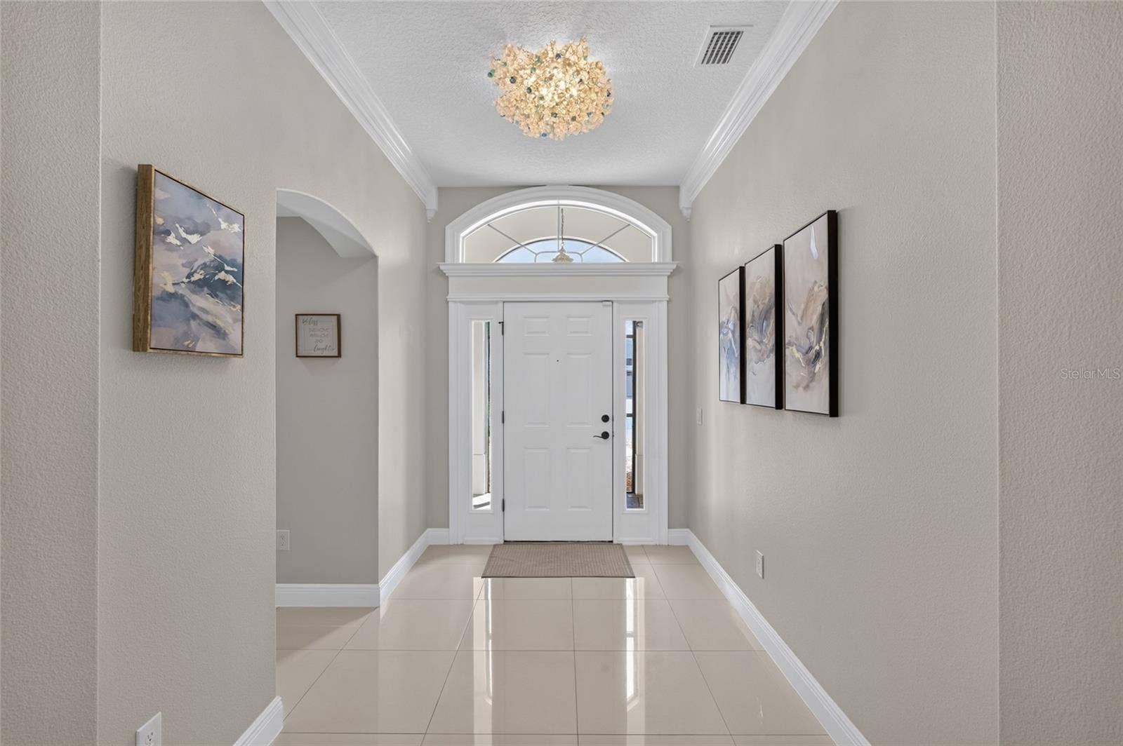 2077 VICKERS PLACE, The Villages, FL 32163 LOOKING AT FRONT DOOR, BEDROOMS 2 AN 3 ARE TO THE LEFT
