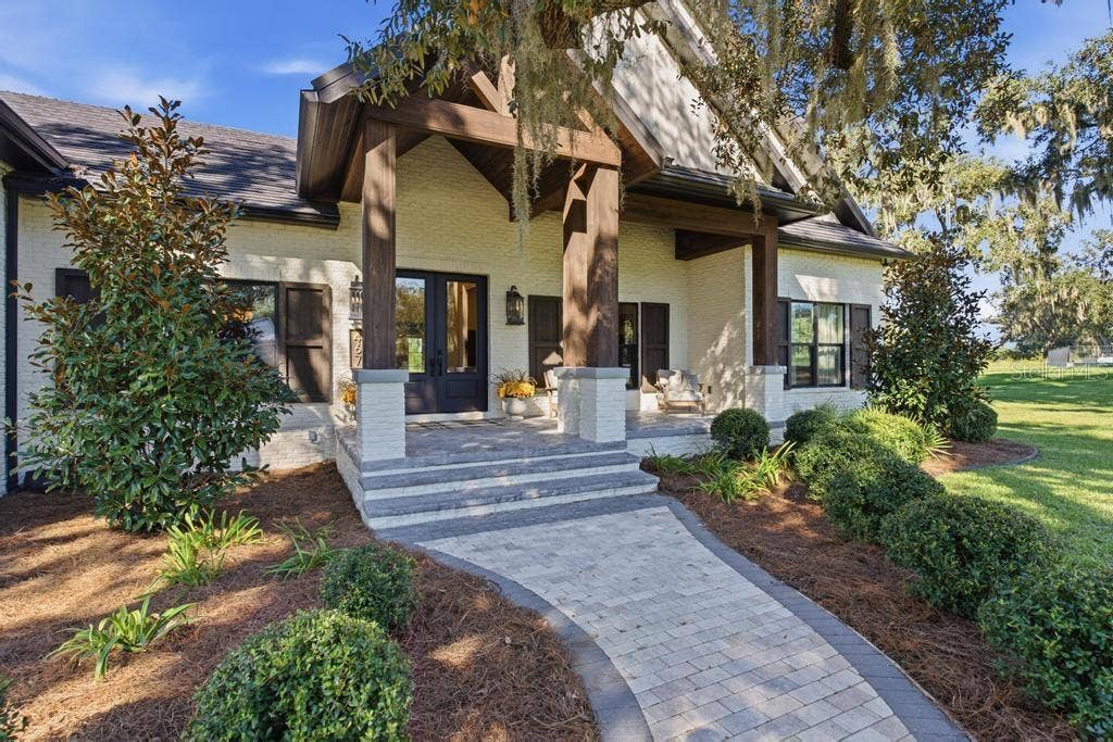 Brick walkway leading to front porch with large sitting area with easy to clean epoxy floors!
