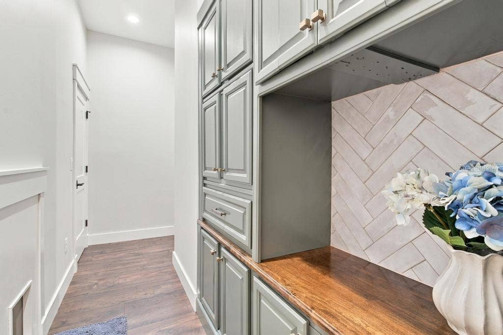 Another entry to laundry room with additional custom cabinetry and walk-in closet