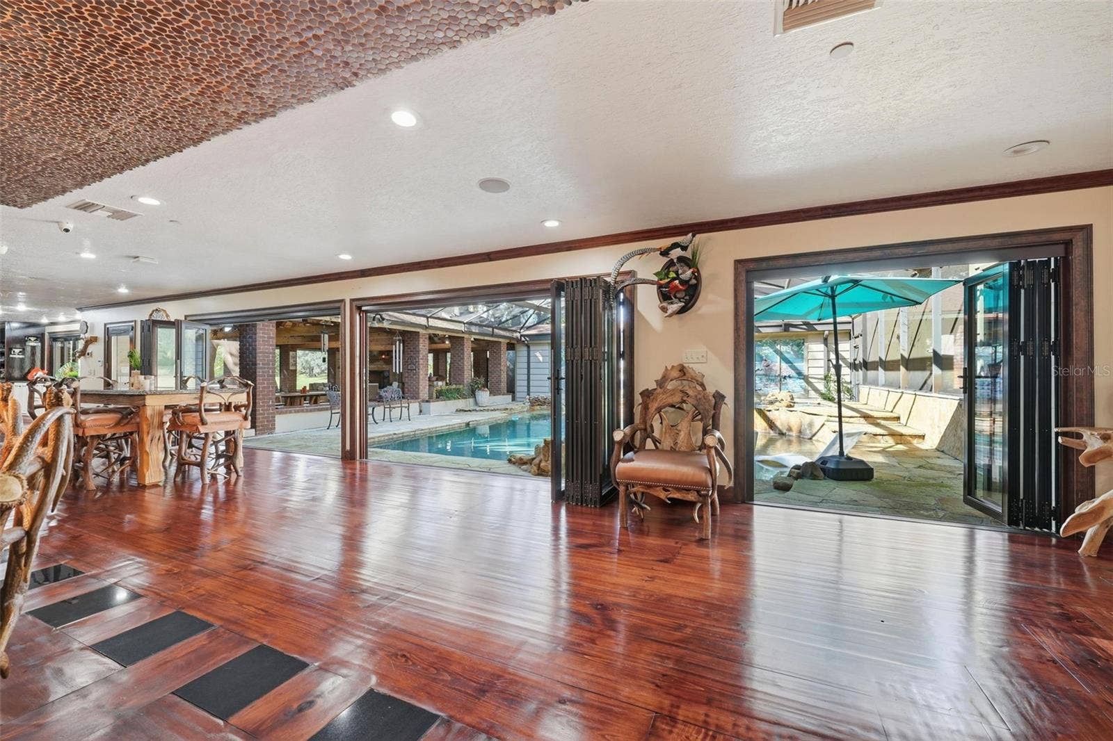 15211 VINOLA PLACE, Montverde, FL 34756 dining-living areas to pool view