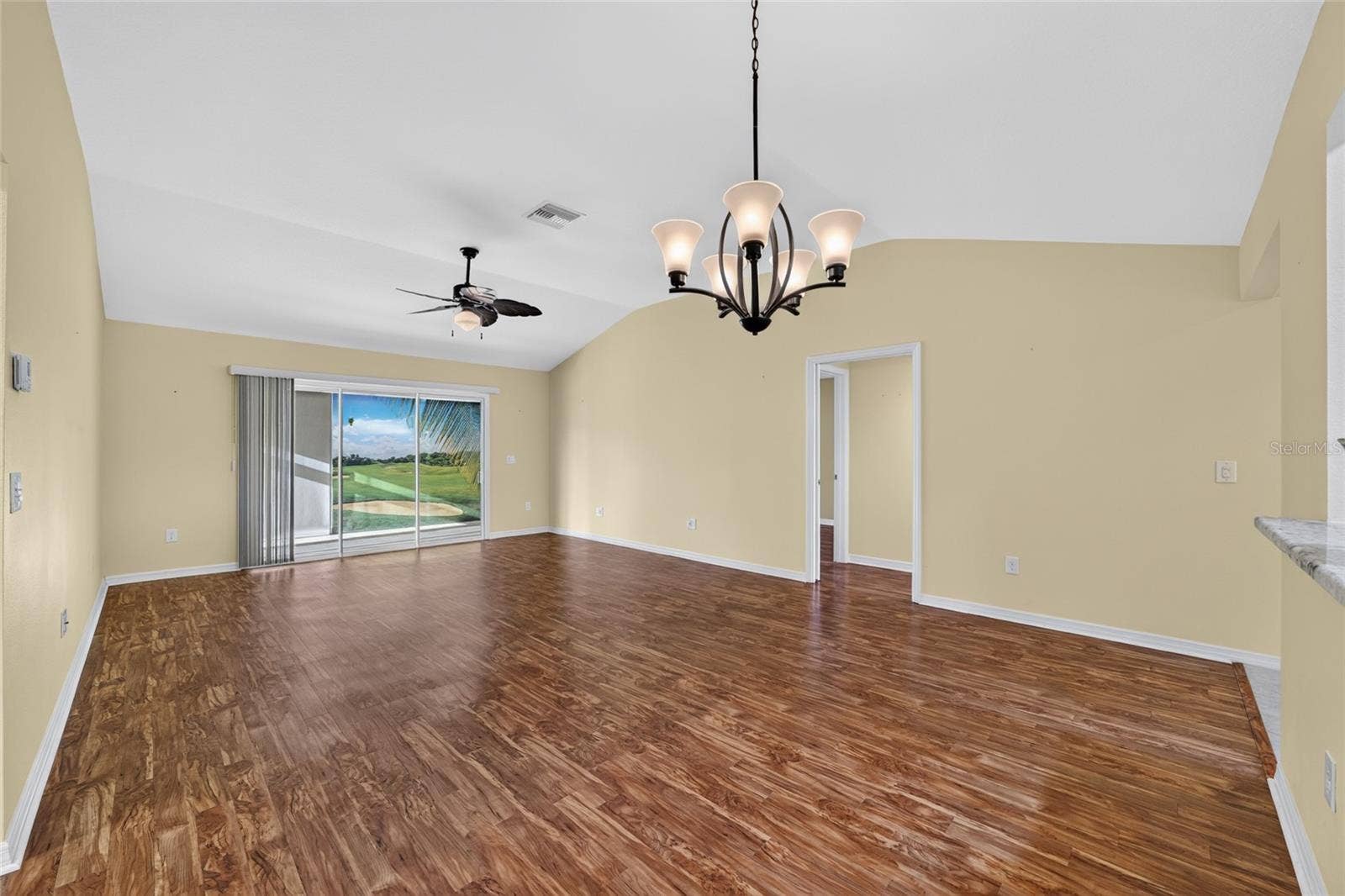 3552 WYNGATE PLACE, The Villages, FL 32163 Glass slider doors from living room to glass enclosed florida room