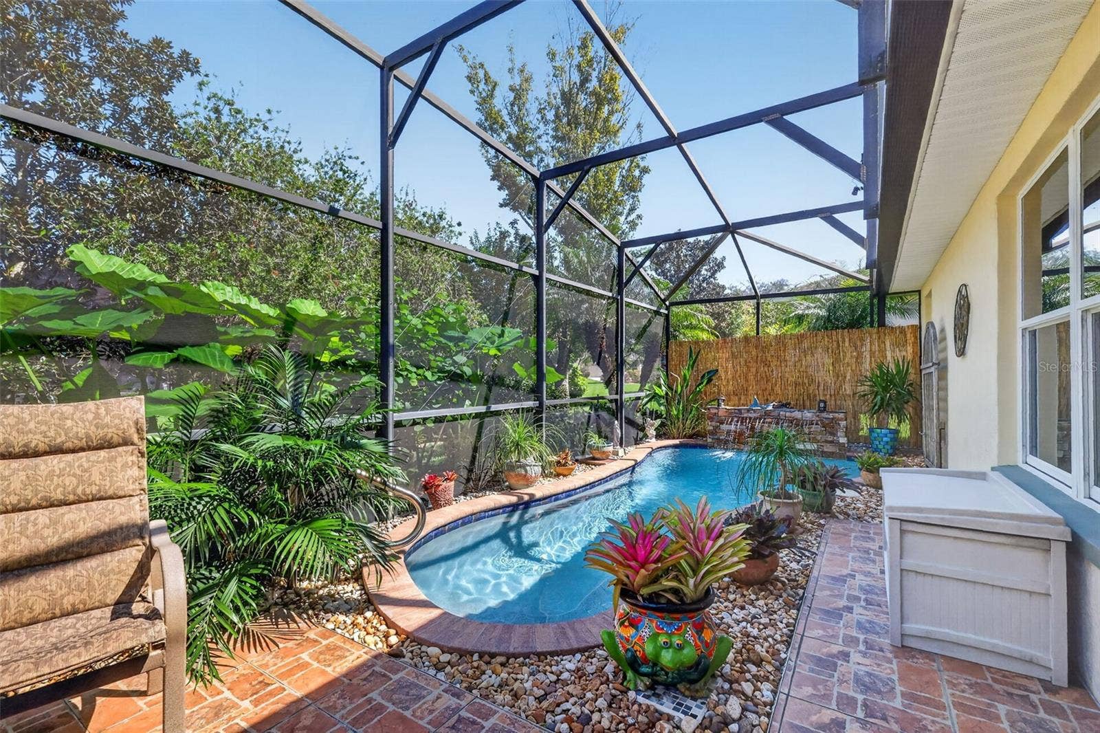 6121 HUNTERS RIDGE AVENUE, Leesburg, FL 34748 Lagoon Swimming Pool with Waterfall and Tropical PRIVACY Landscaping!