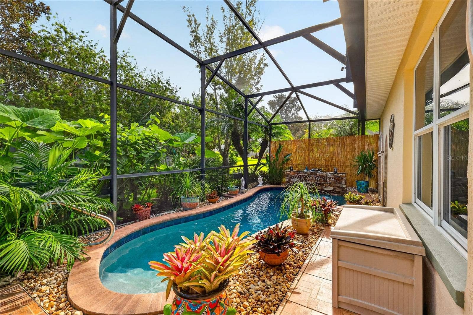 6121 HUNTERS RIDGE AVENUE, Leesburg, FL 34748 Lagoon Swimming Pool with Waterfall and Tropical PRIVACY Landscaping!