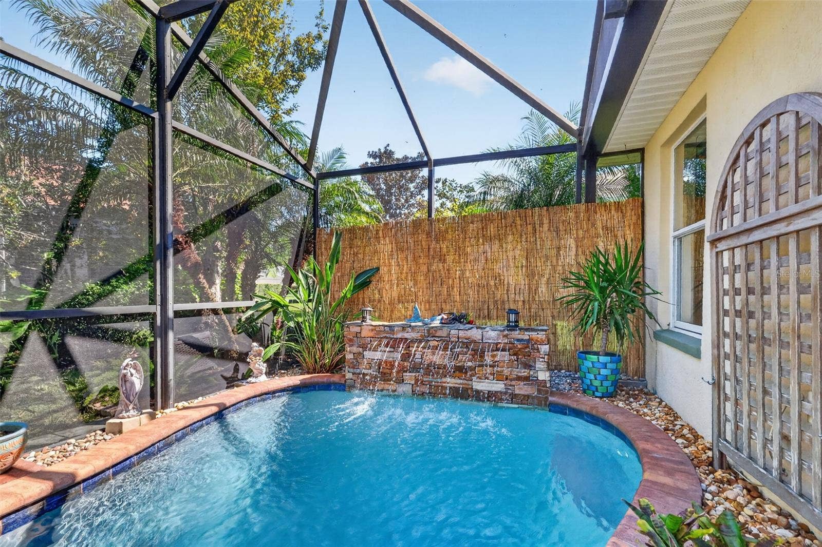 6121 HUNTERS RIDGE AVENUE, Leesburg, FL 34748 Lagoon Swimming Pool with Waterfall and Tropical PRIVACY Landscaping!