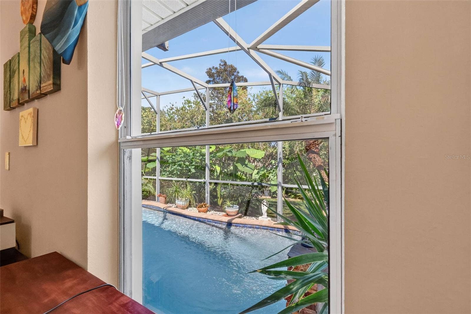6121 HUNTERS RIDGE AVENUE, Leesburg, FL 34748 Tranquil Views of Swimming Pool and Tropical Landscaping from Third Bedroom!