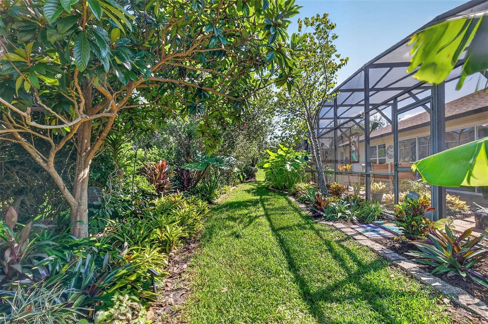 6121 HUNTERS RIDGE AVENUE, Leesburg, FL 34748 Rear Elevation with Tropical PRIVACY Landscaping!
