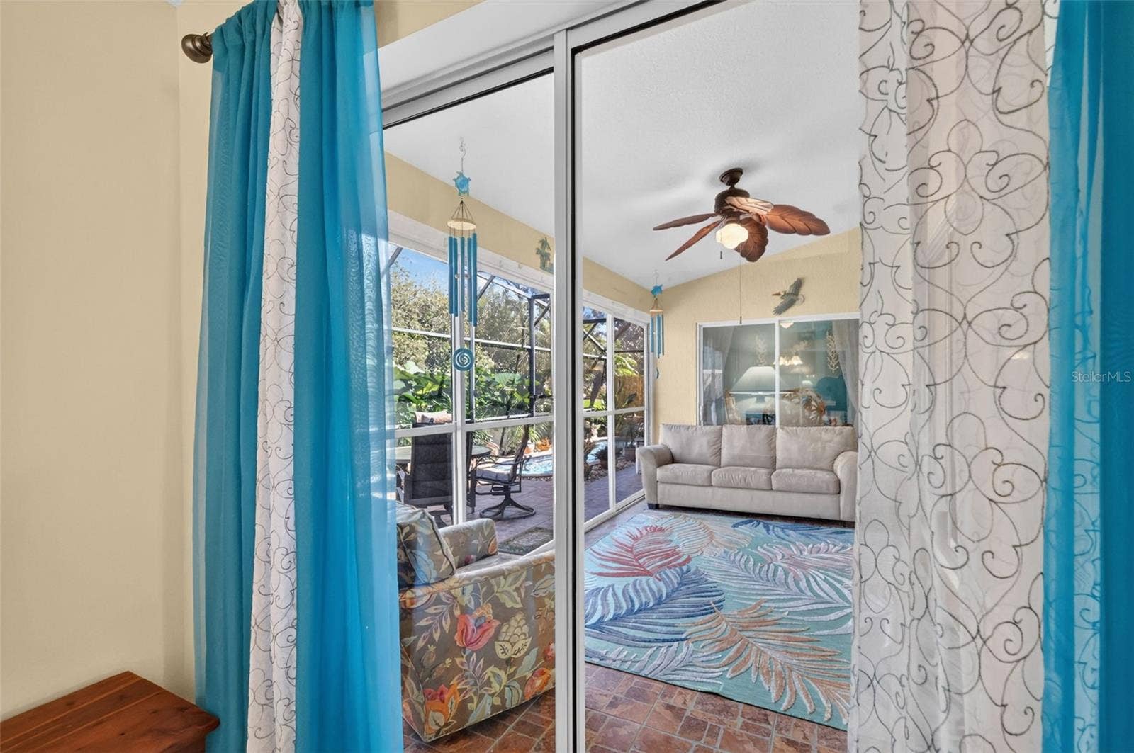 6121 HUNTERS RIDGE AVENUE, Leesburg, FL 34748 Primary Bedroom Sliding Glass Doors to Enclosed Lanai