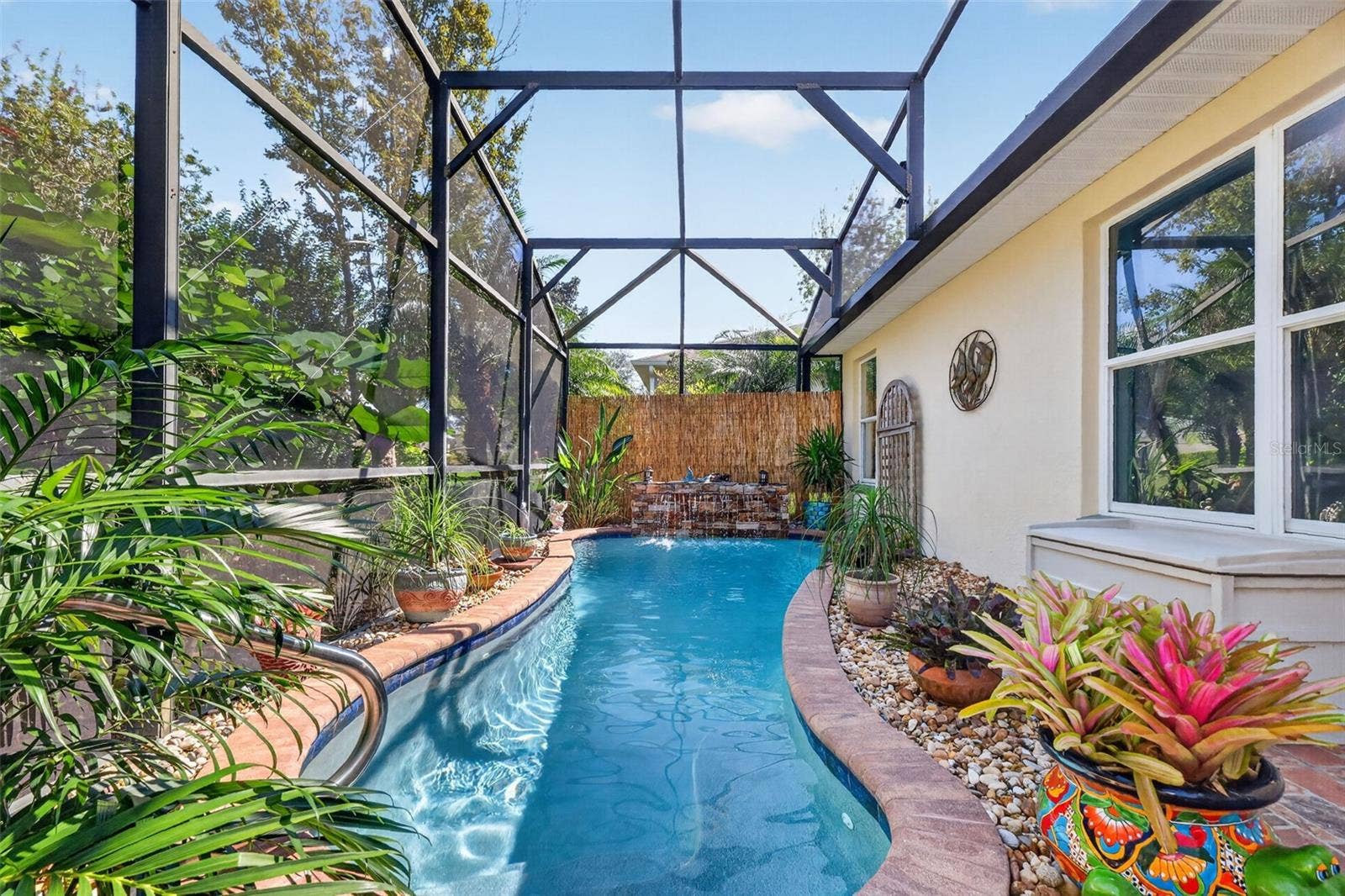 6121 HUNTERS RIDGE AVENUE, Leesburg, FL 34748 Lagoon Swimming Pool with Waterfall and Tropical PRIVACY Landscaping!